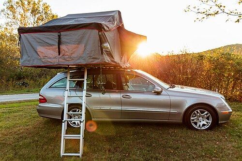 Car with an open roof-top tent