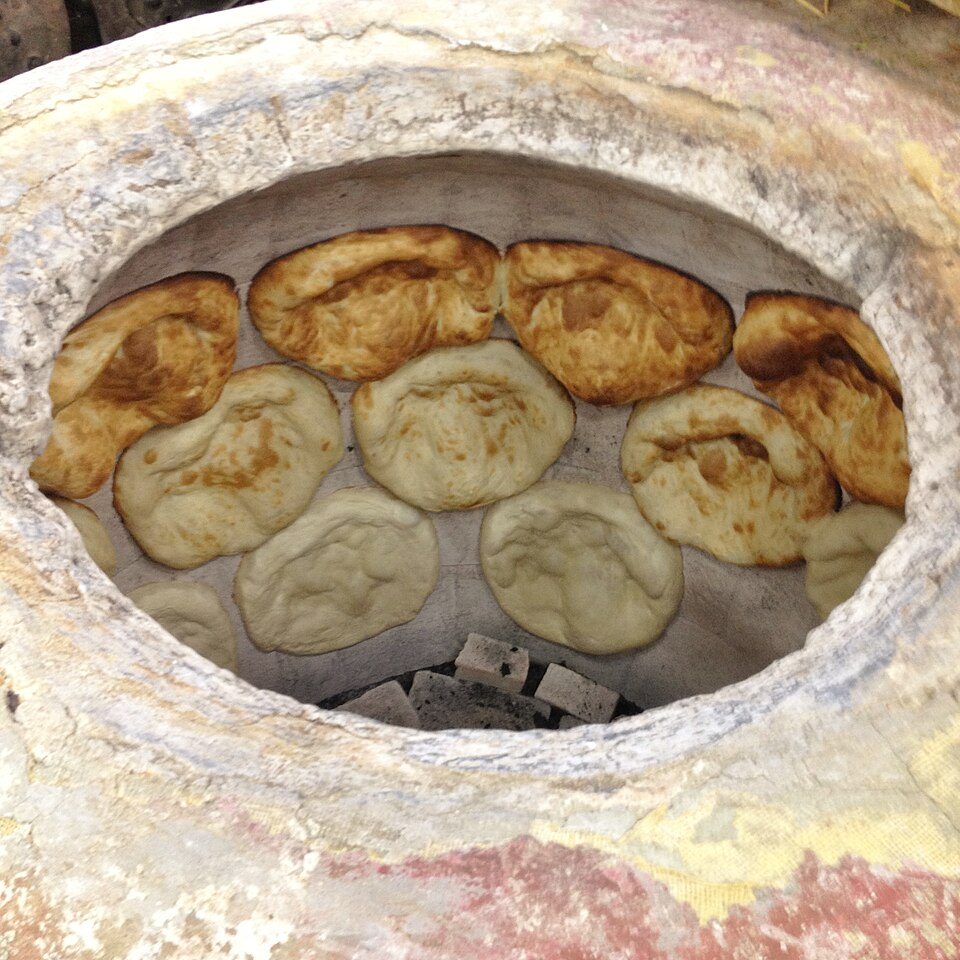 Tonis puri bread baking in a clay tone oven